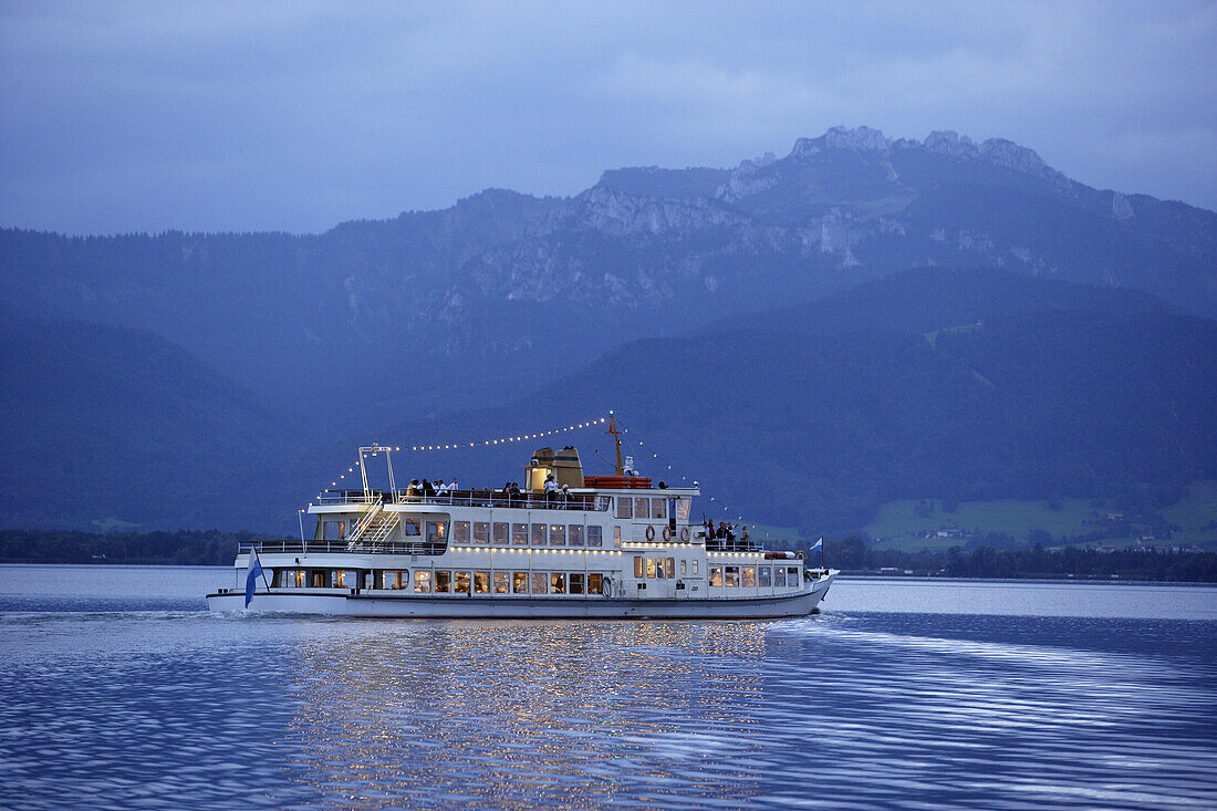 Passenger ferry on lake Chiemsee, mountain Kampenwand in background, Chiemgau, Bavaria, Germany
