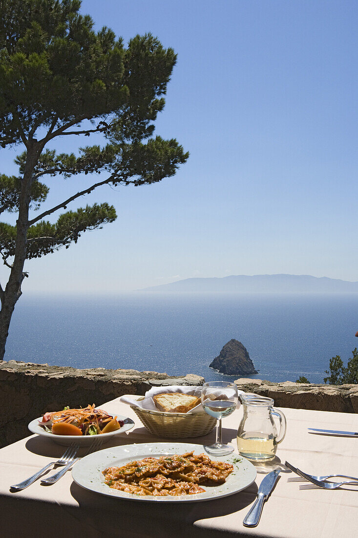 Monte Argentario, terrace of the restaurant Il Bottegone with its view of Giglio island, Monte Argentario, Maremma, Tuscany, Italy