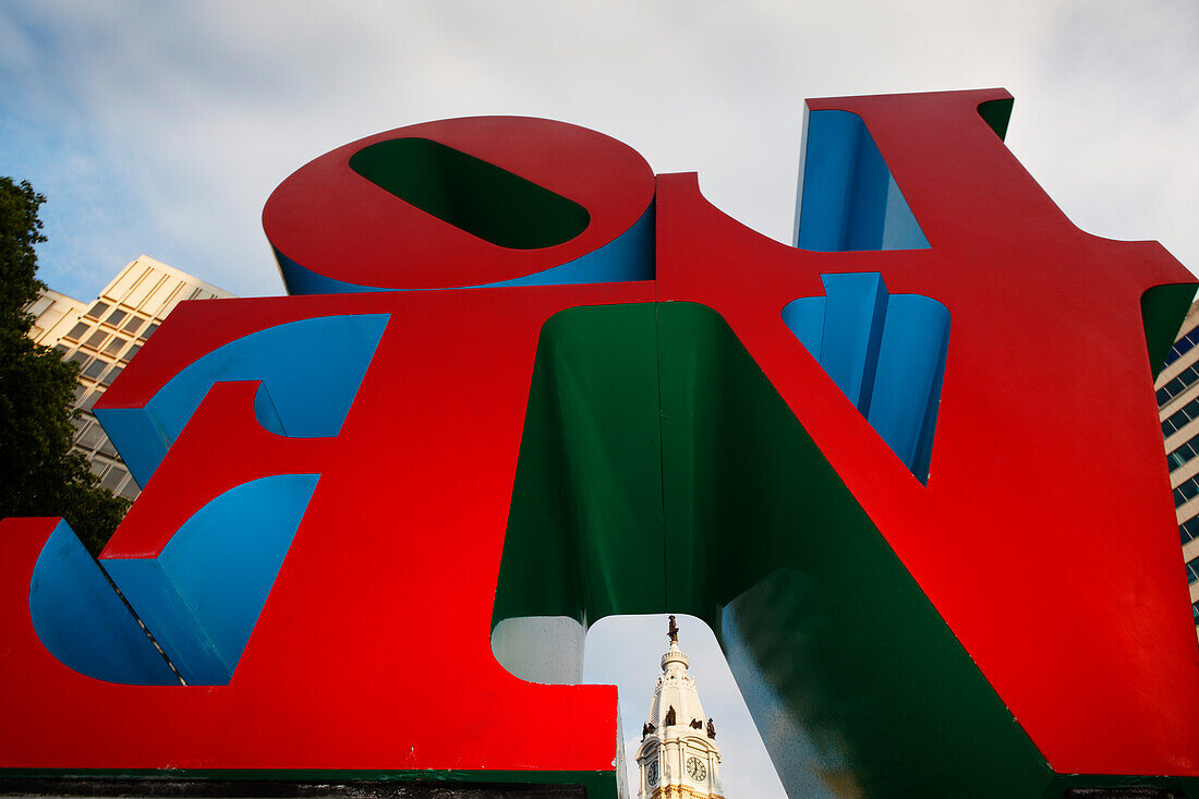 Love sculpture by Robert Indiana in Love Park,with the tower of City Hall in the background, Philadelphia, Pennsylvania, USA