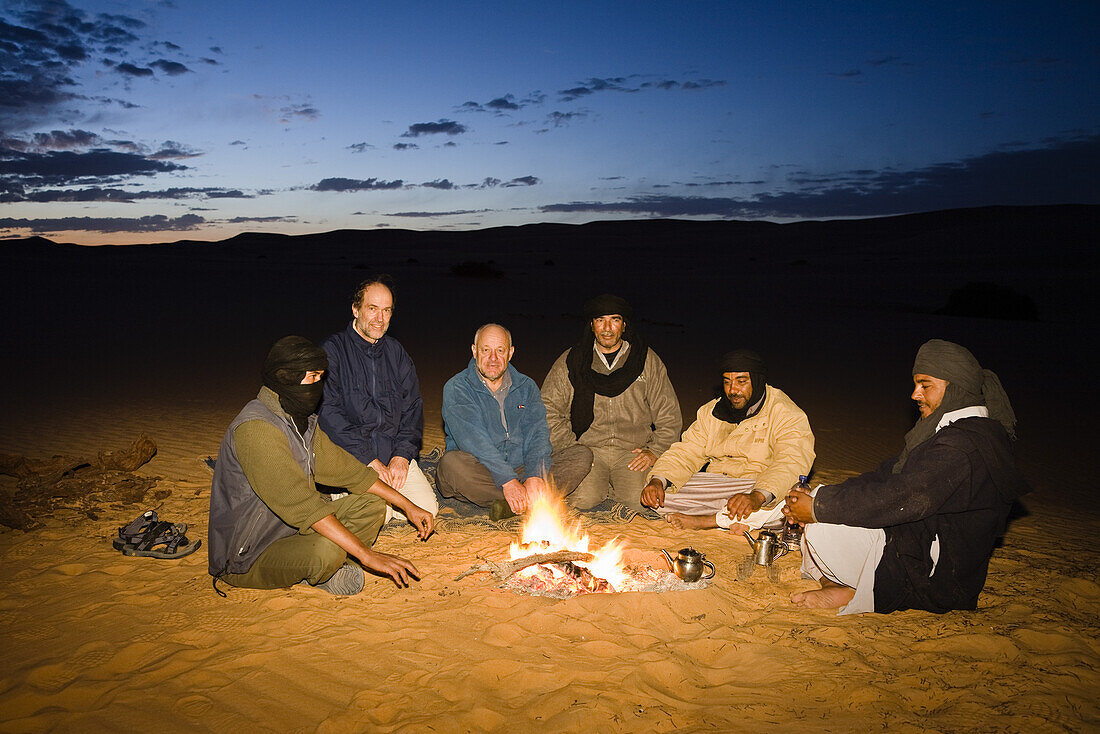 tuaregs with tourists at campfire, Libya, Africa