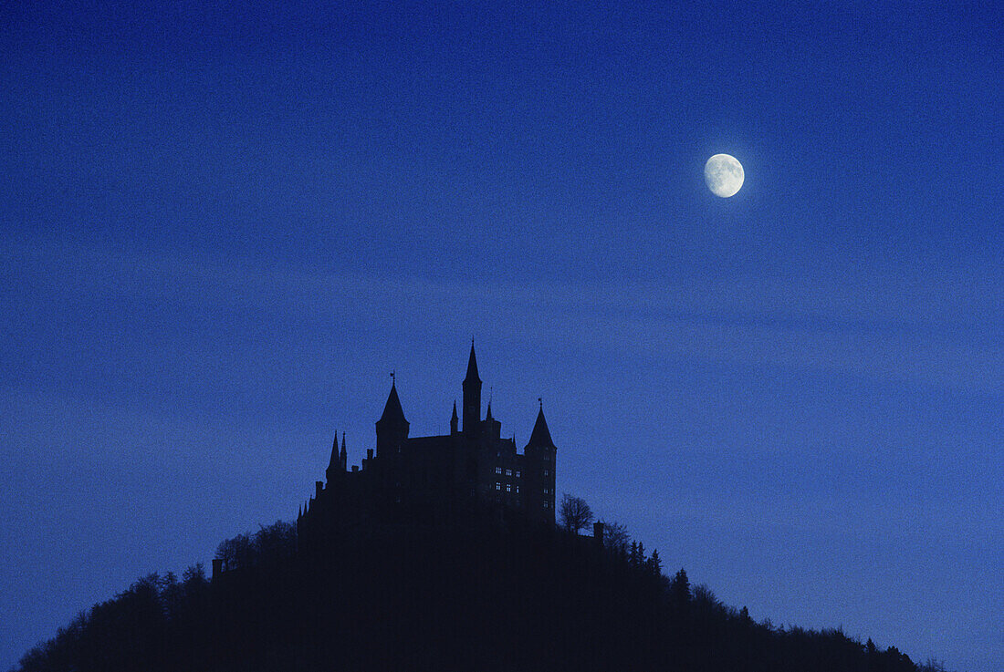 Moon over Hohenzollern castle, Swabian Mountains, Baden-Wuerttemberg, Germany