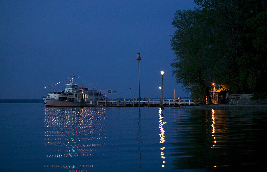 Ferryboat Siegfried at the pier, dusk, Fraueninsel, Lake Chiemsee, Chiemgau, Bavaria, Germany