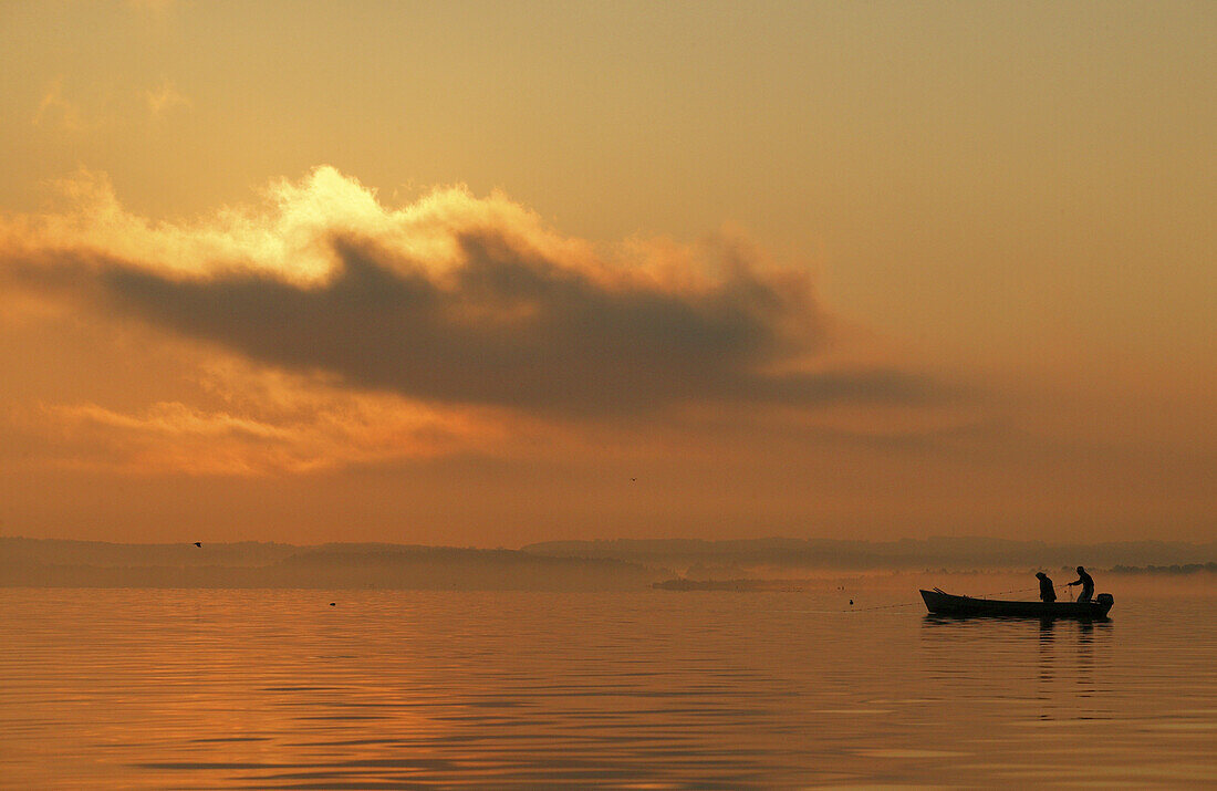 Fishermen at sunrise, Lake Chiemsee, Chiemgau, Bavaria, Germany