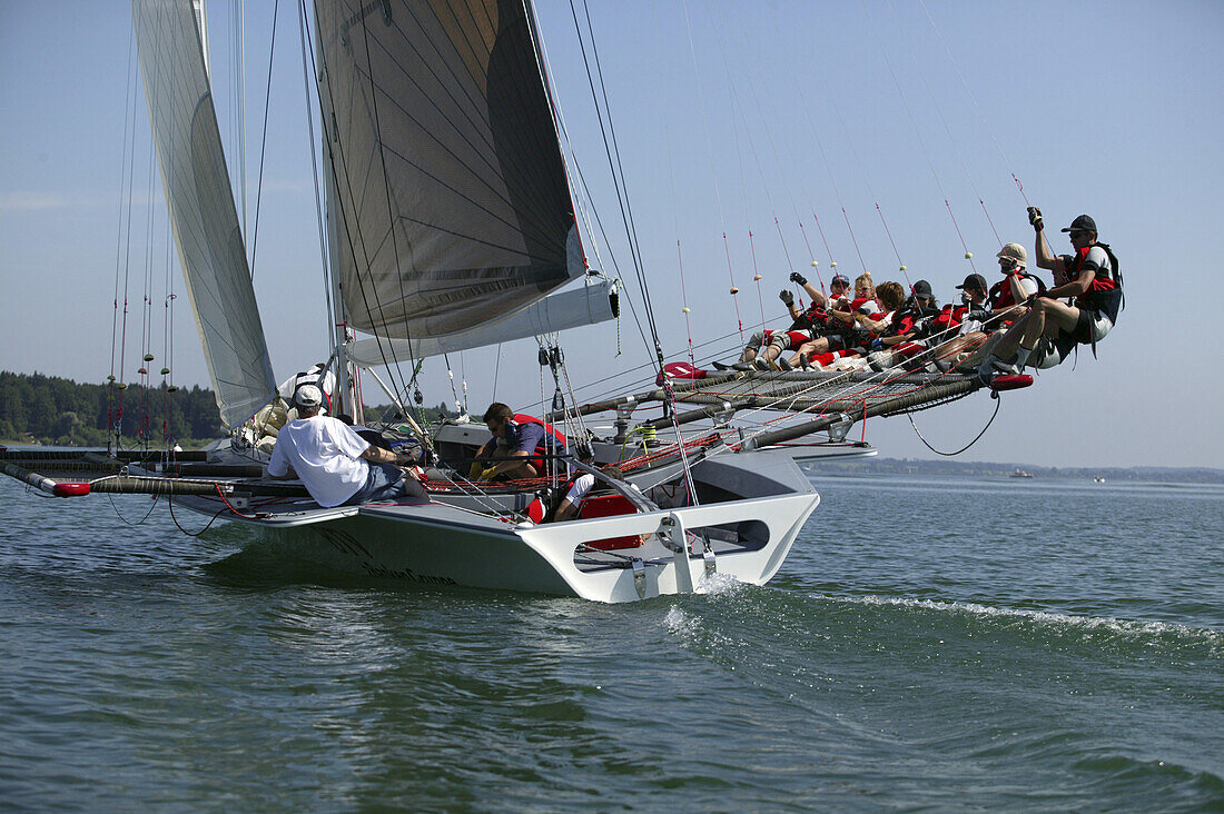Libera sailing yacht, 8 sailors in the trapeze, Chiemsee, Bavaria, Germany