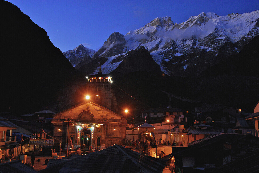 Holy Hindu temple dedicated to Shiva in Kedernath with Kedernath mountains in the evening, Uttarakhand, India, Asia
