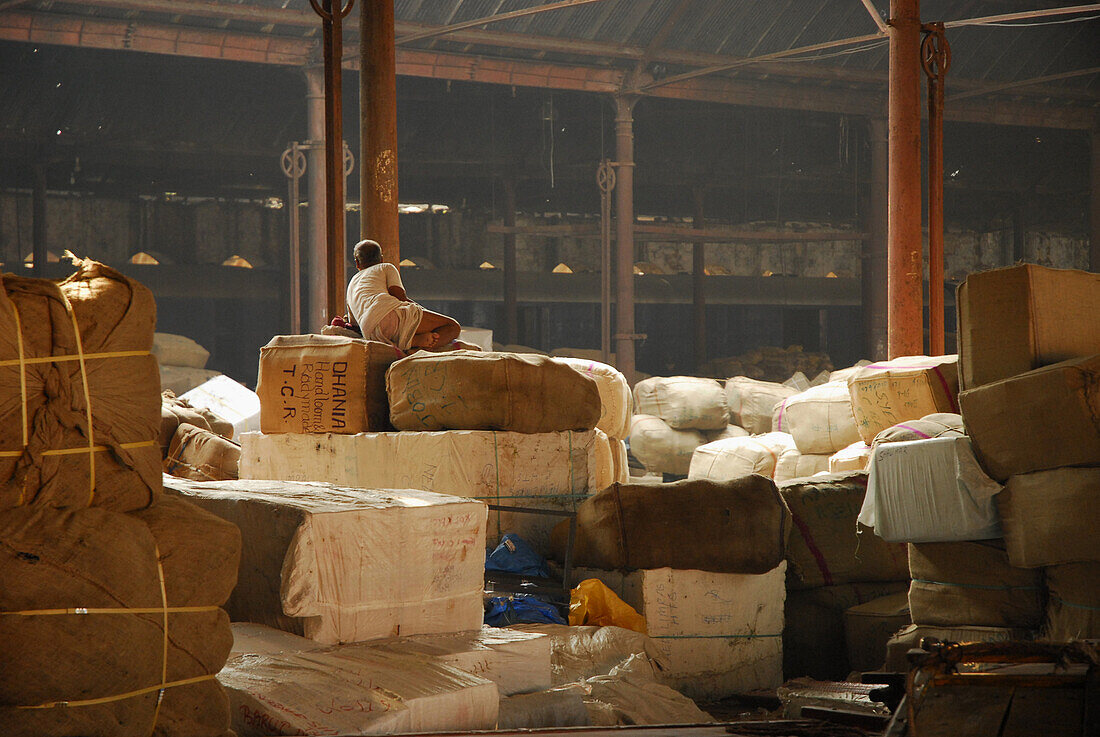Man at a warehouse at Howrah Station in the evening, Howrah, India, Asia