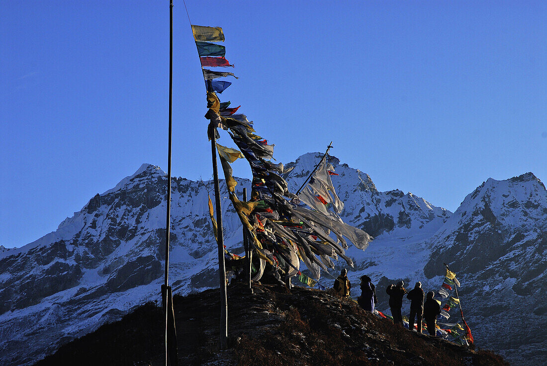 People and prayer flags at Dzongri La, Trek towards Gocha La in Kangchenjunga region, Sikkim, Himalaya, Northern India, Asia