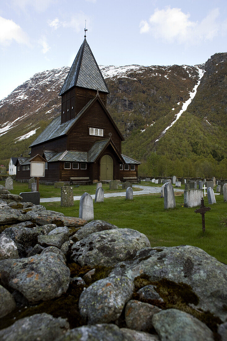 Stave church and graveyard in front of a mountain, Roldal, Hordaland, Norway, Scandinavia, Europe