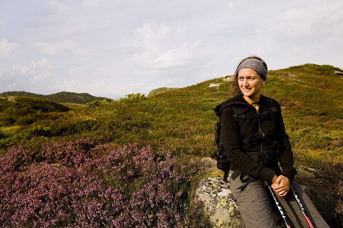 Young woman resting in fjell landscape, Skanevik, Hordaland, Norway, Scandinavia, Europe