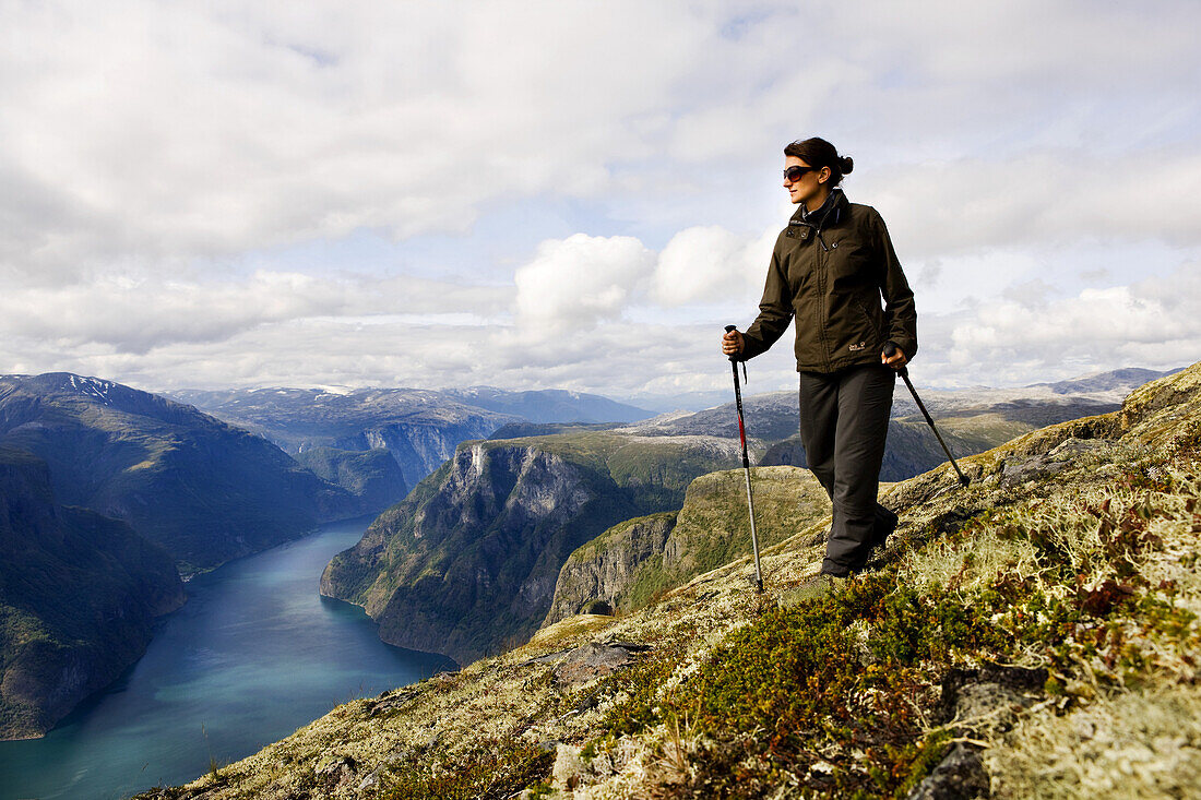 Young woman hiking with a view at the Aurlandsfjord, Prest, Aurland, Sogn og Fjordane, Norway, Scandinavia, Europe