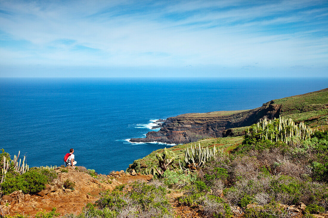 Hiker at the coast looking at the sea, Santo Domingo de Garafia, La Palma, Canary Islands, Spain, Europe