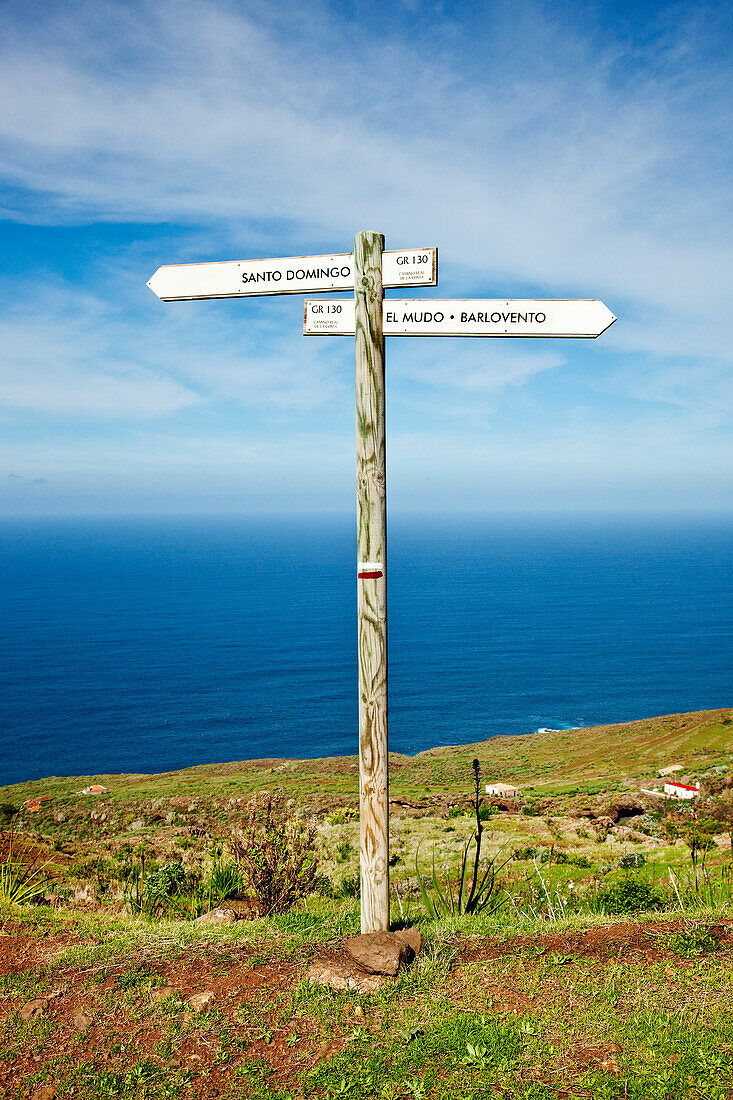 Signpost and ocean under clouded sky, Santo Domingo de Garafia, La Palma, Canary Islands, Spain, Europe