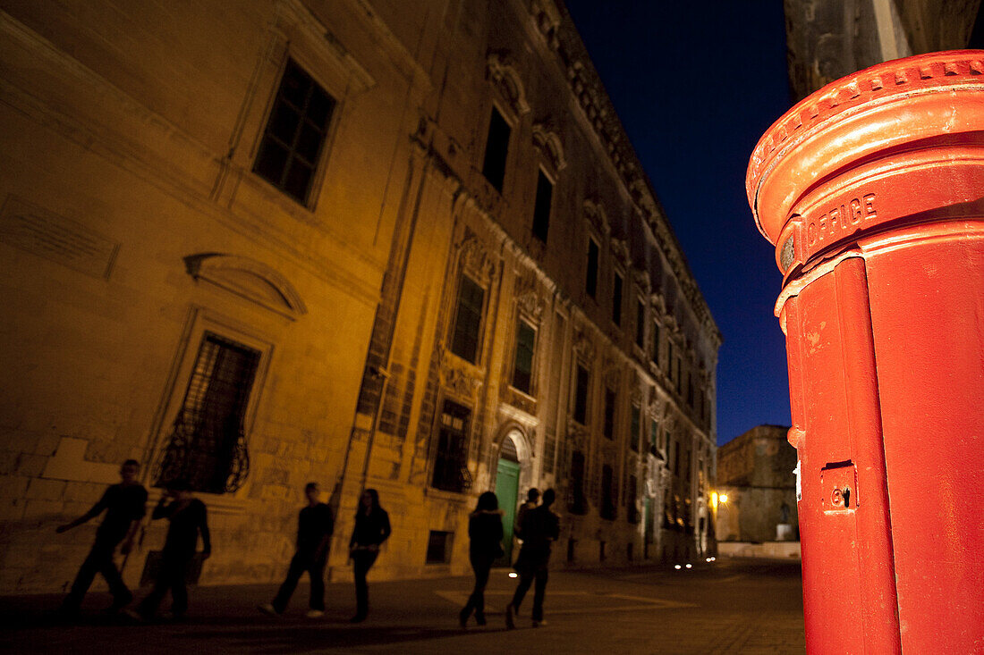 Red letterbox inthe city in the evening, Valletta, Malta, Europe
