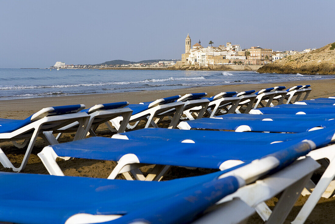 Sunloungers on the deserted beach, Sitges, Catalonia, Spain, Europe