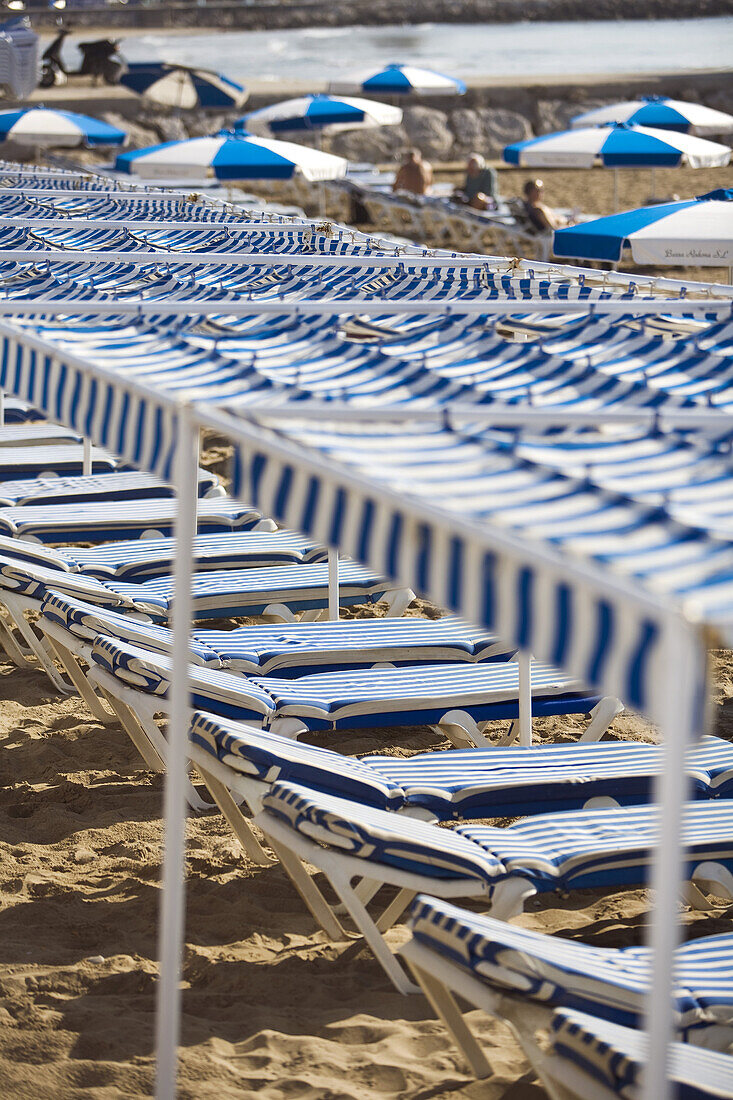 Sunloungers in a row on the beach, Sitges, Catalonia, Spain, Europe