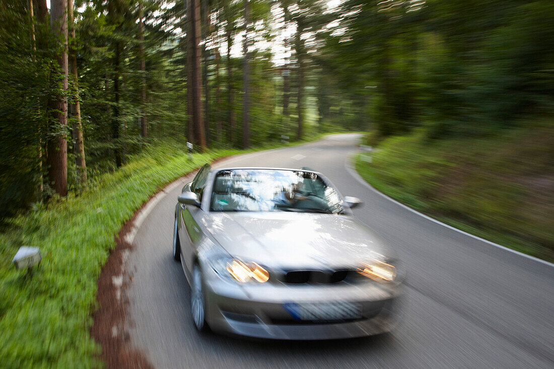 Convertible passing country road, Black Forest, Baden-Wuerttemberg, Germany