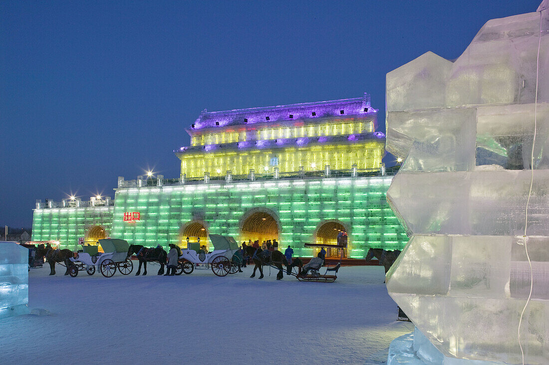 China. Heilongjiang. HAERBIN  Harbin): Haerbin Ice and Snow World Festival. All Buildings built of ice. Entrance Gate and Horse Drawn Carriages