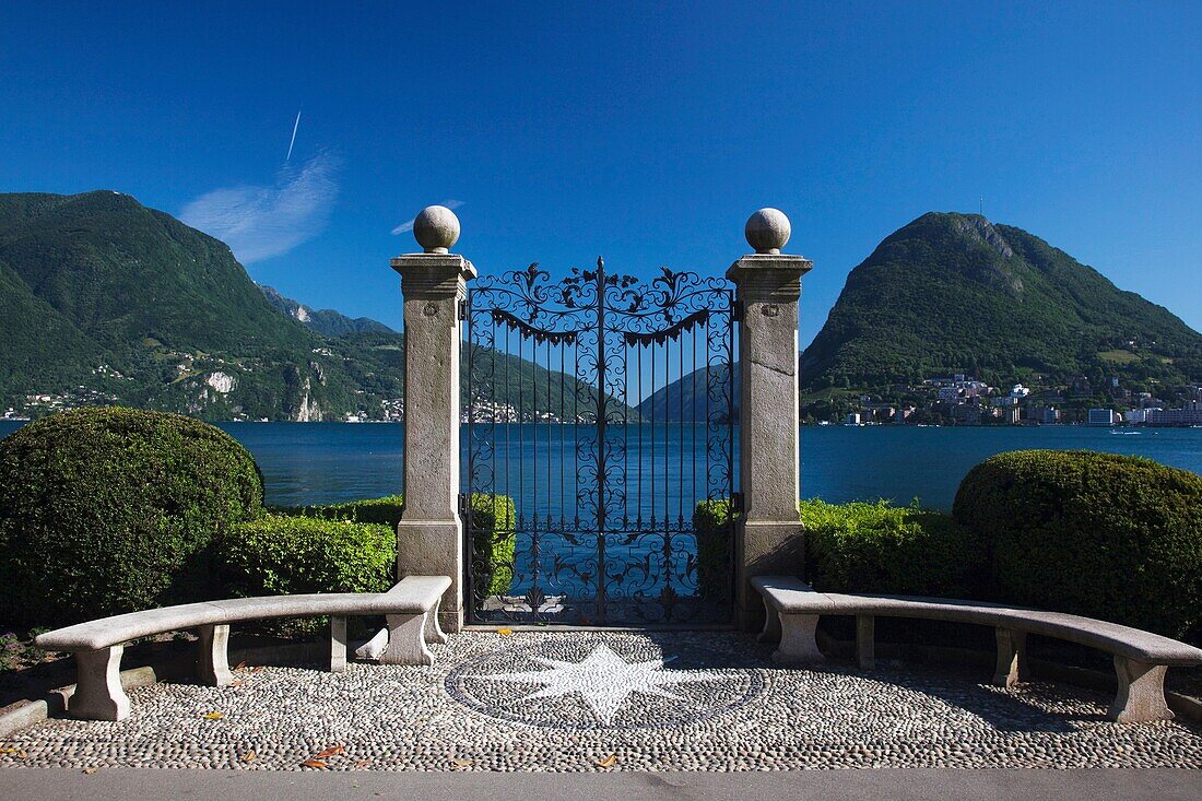 Switzerland, Ticino, Lake Lugano, Lugano, Parco Civico, view towards Monte San Salvador though gates