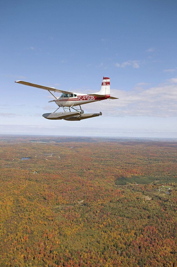 Flying over East counties in seaplane at fall, Quebec, Canada