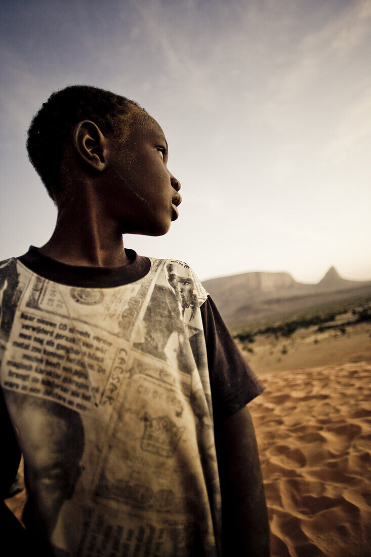 African boy in the sand dunes, Hombori, Mali, Africa