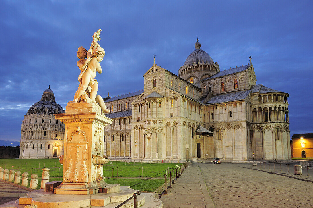 Illuminated baptistery and Pisa cathedral with fountain in the foreground, Pisa, UNESCO world heritage site, Tuscany, Italy
