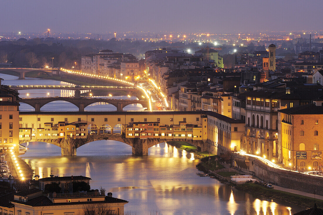 Illuminated Ponte Vecchio bridge with the river Arno, Florence, UNESCO world heritage site, Tuscany, Italy