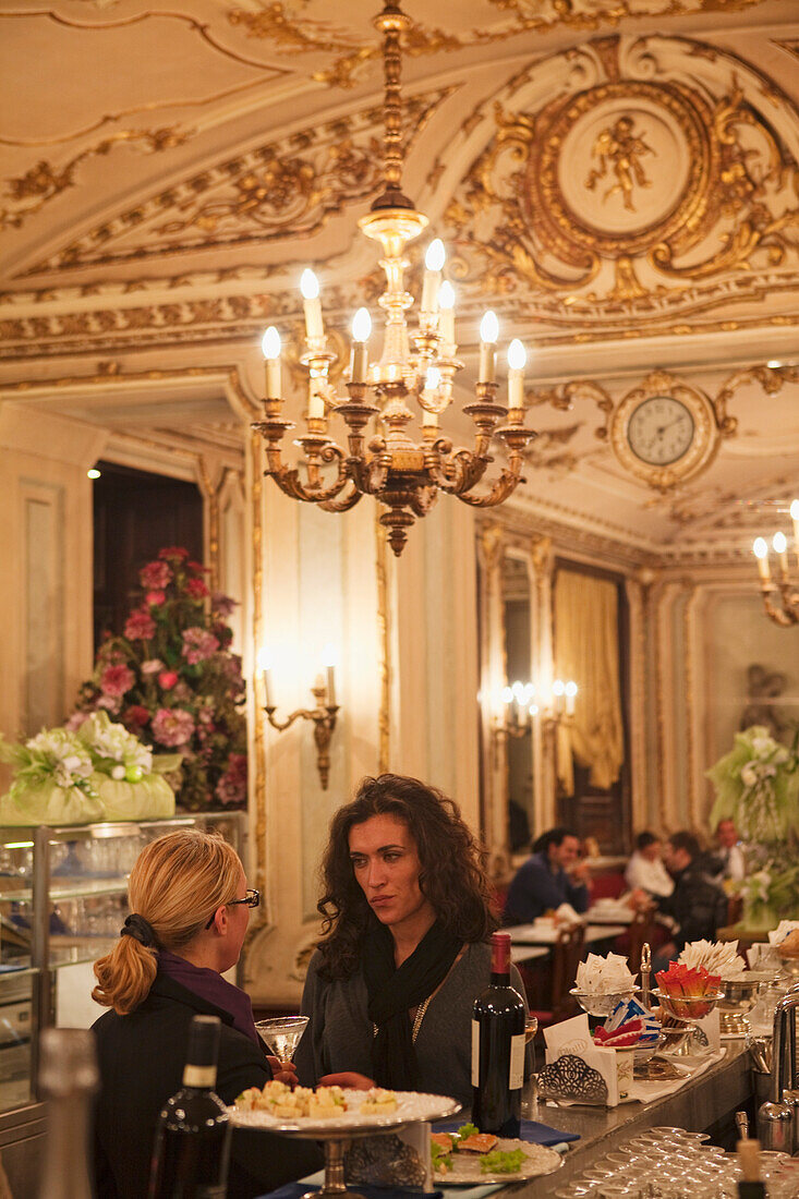 Two women having a conversation in Cafe Platti, Turin, Piedmont, Italy