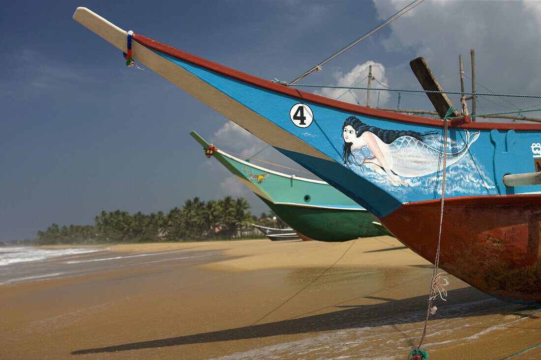 Outrigger fishing boats on Hikkaduwa beach, Sri Lanka
