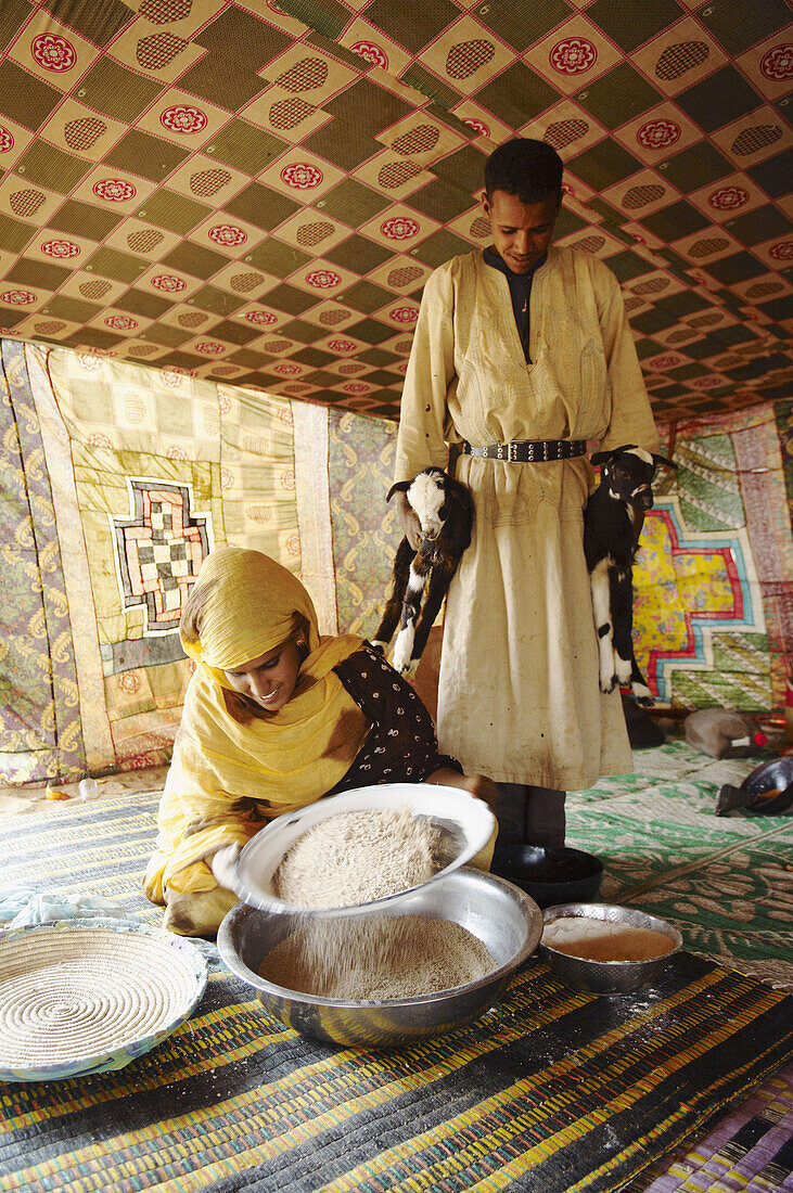 Woman preparing couscous, Chinguetti. Adrar Plateau, Sahara Desert, Mauritania
