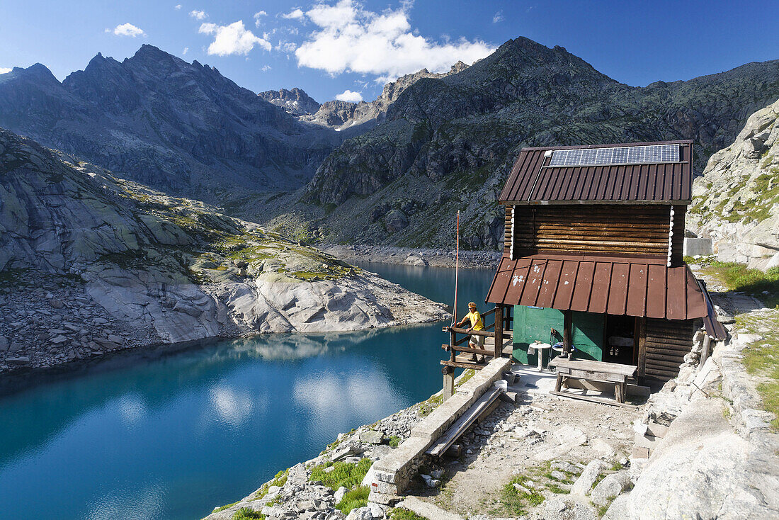 Mountain hut Rifugio Pocchiola Meneghello at mountain lake Lago di Valsoera, Alta Via del Canavese, Gran Paradiso National Park, Piedmont, Italy