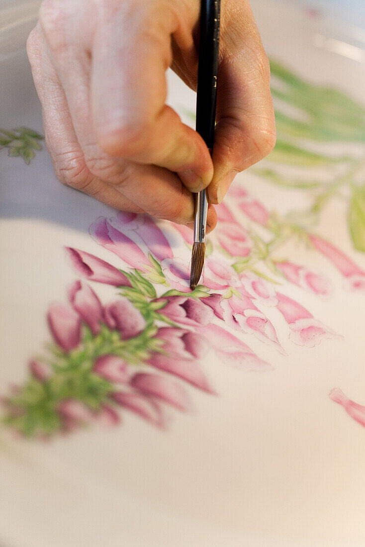 Porcelain painter in the Royal Copenhagen Flagshipstore, Amagertorv, Copenhagen, Denmark