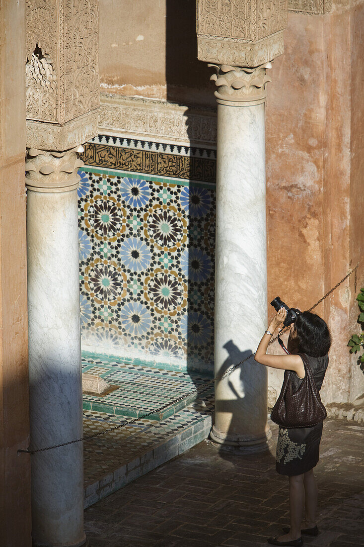 Tourist taking a photo, visiting the Saadian Tombs, Marrakech, Morocco, Africa