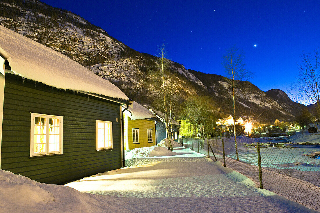 Snow-covered huts at night, Rjukan, Telemark, Norway