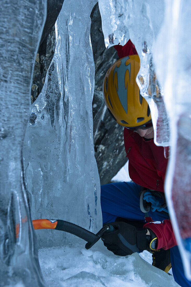 Ice climber in an icefall, Rjukan, Telemark, Norway