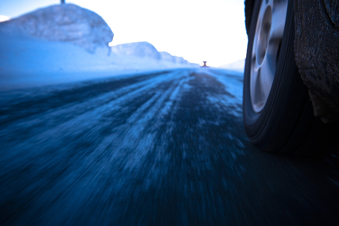 Car passing road in winter, Norway