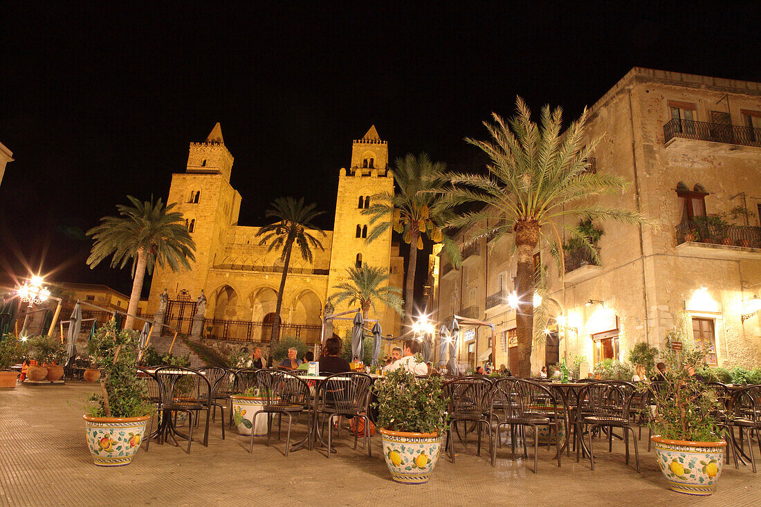 People at a restaurant in front of San Salvatore Cathedral at the square Piazza Duomo at night, Cefalù, Province Palermo, Sicily, Italy, Europe