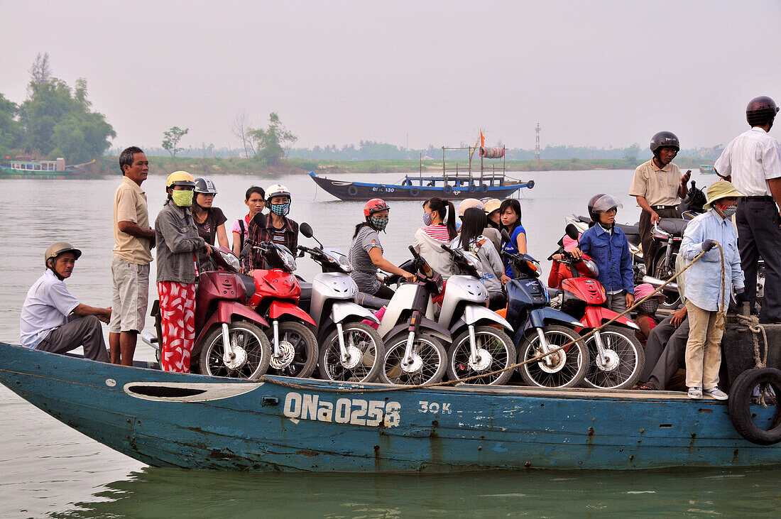 Ferry boat with mopeds on the Thu Bon river in Hoi An near Da Nang, Vietnam