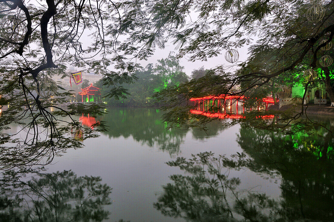 View across Hoan Kiem lake with temple of Ngoc Son in the background, old town of Hanoi, Vietnam