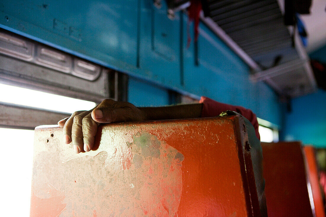 Sinhalese man relaxing in the train between Colombo and Badulla, Nuwara Eliya, Highland, Sri Lanka, Asia