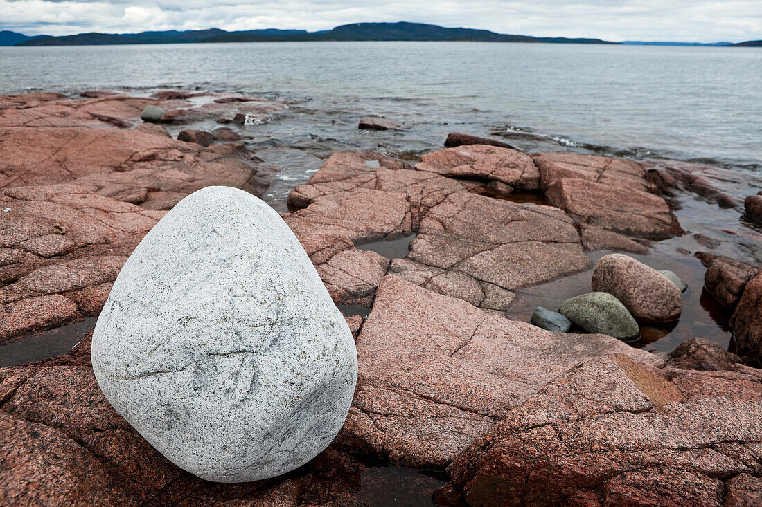 White boulder on red granit rocks at the Höga Kusten, bay of Storsands Havsbad, Vaesternorrland, Sweden, Europe