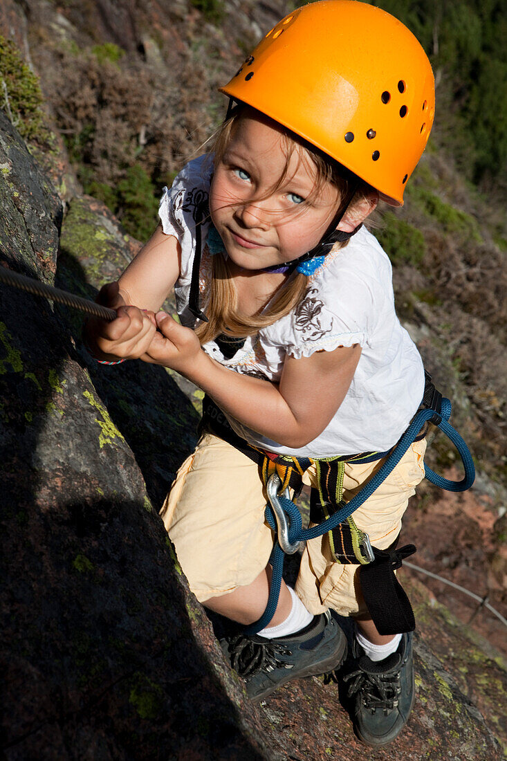 Girl climbing at fixed rope route at Skuleberget, Höga Kusten, Vaesternorrland, Sweden, Europe