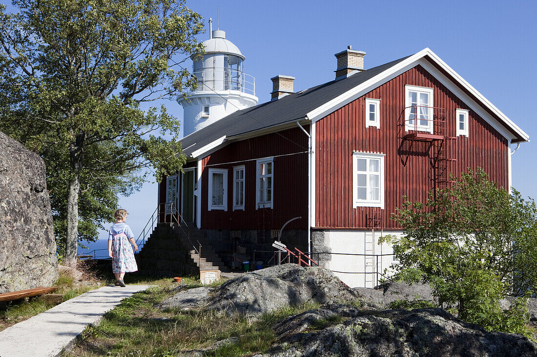 Holzhaus und Leuchtturm Högbonden unter blauem Himmel, Höga Kusten, Västernorrland, Schweden, Europa