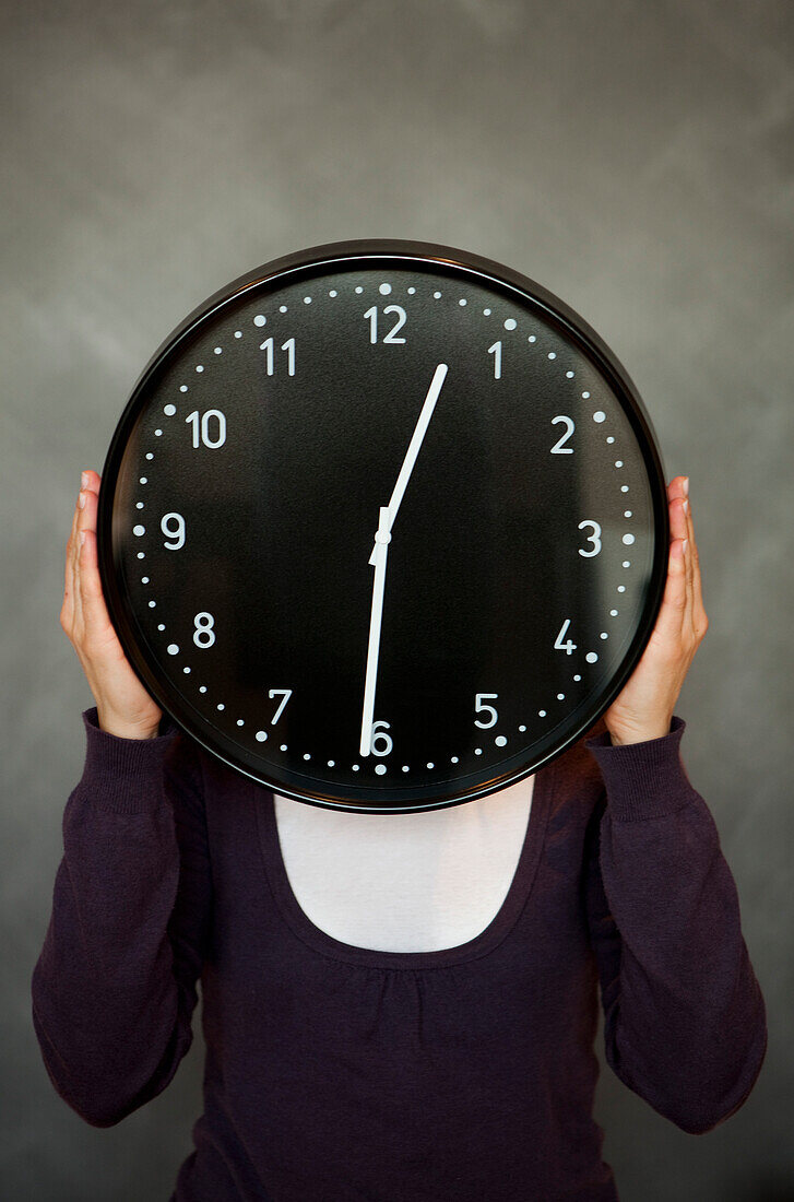 Woman holding a clock