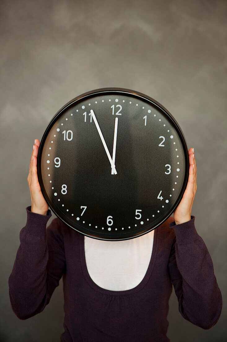 Woman holding a clock