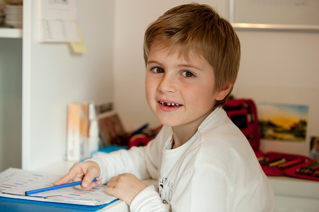 Boy (6 years) doing homework