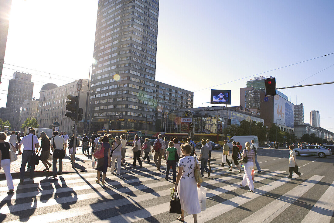 People crossing the Al Jana Pawla II street at Rondo ONZ, Warsaw, Poland, Europe