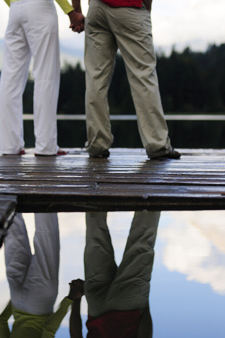 Couple on jetty, Lake Lautersee, Mittenwald, Werdenfelser Land, Upper Bavaria, Germany