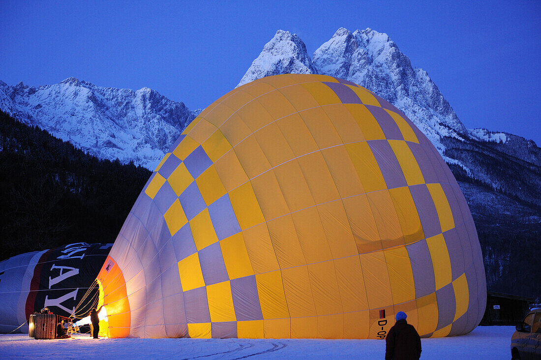 Two hot-air balloons lying on the ground and being filled, Waxensteine in background, Garmisch-Partenkirchen, Wetterstein range, Bavarian alps, Upper Bavaria, Bavaria, Germany, Europe