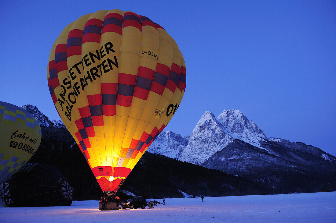Three hot-air balloons being filled, Waxensteine in background, Garmisch-Partenkirchen, Wetterstein range, Bavarian alps, Upper Bavaria, Bavaria, Germany, Europe