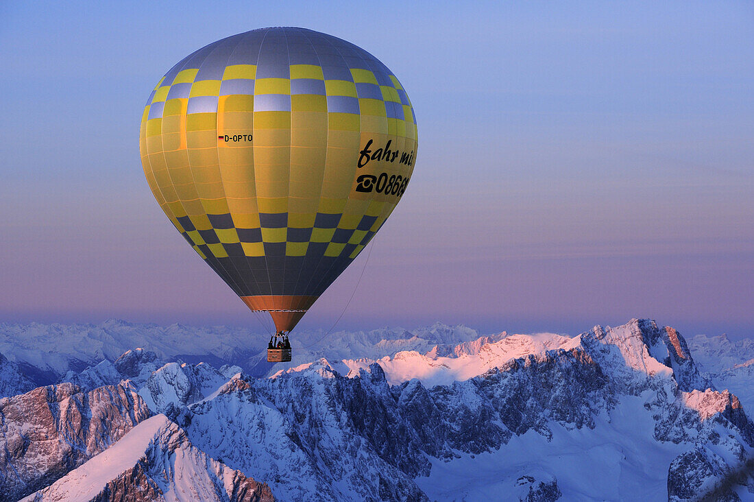 Aerial view of hot-air balloon flying above Alpspitze, Jubilaeumsgrat and Zugspitze, Garmisch-Partenkirchen, Wetterstein range, Bavarian alps, Upper Bavaria, Bavaria, Germany, Europe